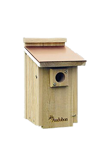 Front view of a wooden Audubon bluebird house with a copper roof and tan body.