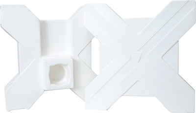 Close-up of a white Horsemen's Pride Cavalletti component with a central hole and X-shaped design