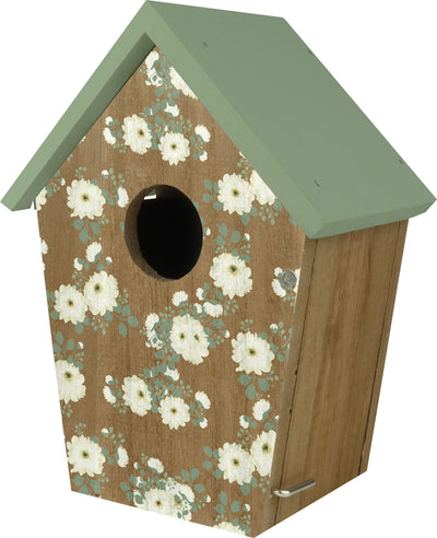 Front view of a wooden birdhouse with green roof and white floral pattern on brown background.