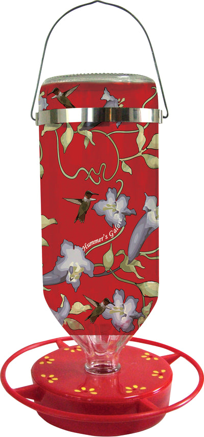 Red hummingbird feeder with floral and hummingbird design, brand name visible, front view.