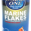 Front view of Omega One Marine Flakes container with blue label, garlic flavor, 2.2 oz size, and clownfish illustration.