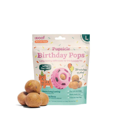 Packaged Woof Birthday Pops Large PB & Cake Flavor refill treats with pink Pupsicle toy illustration and loose treats in front.