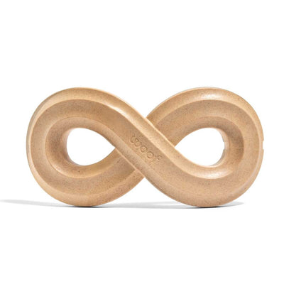 Close-up of a light brown wooden infinity-shaped chew toy with 'woof' engraved on it.