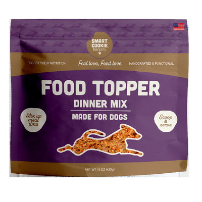 Front view of a purple and brown packaged Smart Cookie Barkery dog food topper mix, 15 oz.