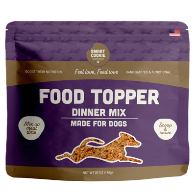 Front view of a purple and brown packaged Smart Cookie Barkery dog food topper, 7 oz.
