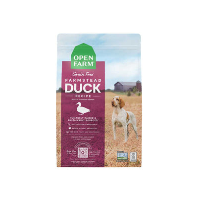 Front view of Open Farm Farmstead Grain Free Duck Recipe dry dog food bag, 22lb, purple and green packaging with dog in field.