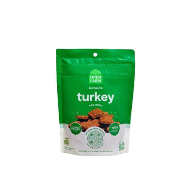 Front view of a green and white packaged Open Farm dehydrated turkey dog treats bag, 4.5 oz.