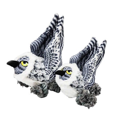 Two plush snow owls with black and white striped wings, yellow eyes, and black beaks in a side view.