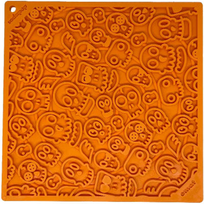 Close-up of an orange Sodapup Soda Pup Nylon Enrichment Sp Emat Holiday Zombie toy mold with various zombie-themed shapes.