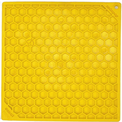 Close-up of a yellow Sodapup Honey flavor enrichment mat with hexagonal patterns and brand text.