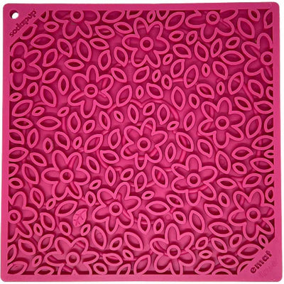Close-up of a pink Sodapup Nylon Enrichment Sp Emat with floral and leaf patterns.