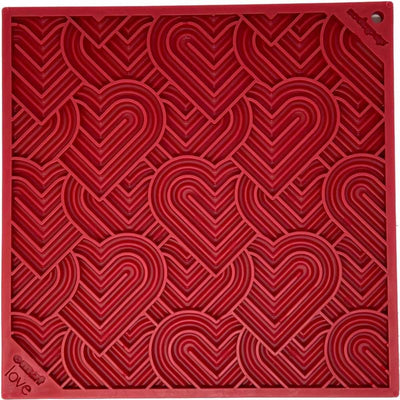Close-up of a red plastic mold with layered heart shapes and 'love' text in bottom left corner.