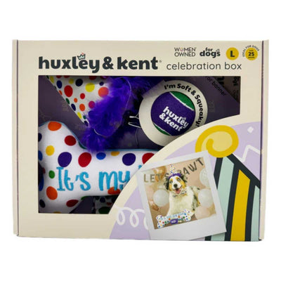 Packaged Huxley & Kent dog celebration box with colorful items visible through window