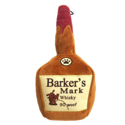 Front view of a plush dog toy shaped like a bottle labeled 'Barker's Mark Whisky 90 woof' with a red cap and paw print emblem.