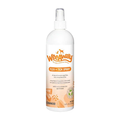 Front view of a white Wee Away Flea + Tick Spray bottle with orange label and cedarwood imagery.