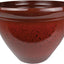 Close-up of a glossy red resin planter with black speckles, 12 inches in diameter.