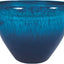 Close-up of a blue resin planter with a textured surface and two drainage holes on the rim.