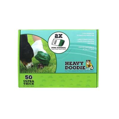 Packaged product: green box of Heavy Doodie pet waste bags with 50 ultra thick bags shown in use on grass.
