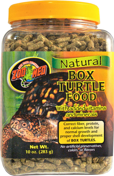 A clear front view of a Zoo Med Natural Box Turtle Food jar with yellow lid and brown pellets inside.