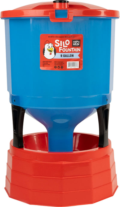 Blue and red Happy Hen Silo Fountain 9-gallon water container with a red base and black supports.