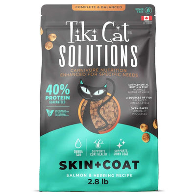 Front view of a Tiki Cat Solutions Skin+Coat salmon & herring recipe cat food bag, 2.8 lb, black and teal packaging.