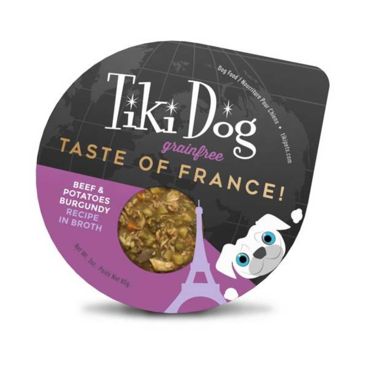 Packaged Tiki Dog grain-free dog food cup with 'Taste of France' label, purple and black design, showing beef and potatoes burgundy recipe in broth.