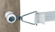 Close-up of a white Dare Electric Fence End Tension unit attached to wood with a metal bracket and white woven strap.