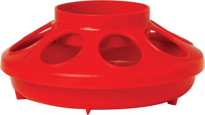 Close-up of a red plastic poultry feeder base with four circular openings and a central tube, viewed from the front.