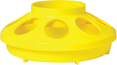Close-up of a yellow plastic poultry feeder base with three circular openings and a raised rim.